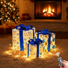 Aurelema front view of three lit gift boxes showing festive presentation and warm glow