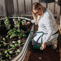 Backyard Expressions in-use image of gardener kneeling using seat to reduce joint strain