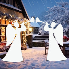 Barydat angel silhouette at night with lights nearby enhancing evening nativity display