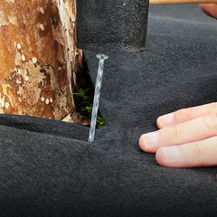 CAROYINO stakes installed along artificial turf edge providing secure, wind-resistant hold