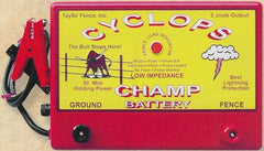 Cyclops Champ mounted on fence post with 12V battery connection demonstrating portable power