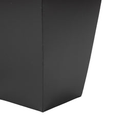 deco 79 planters next to chair showing scale and placement benefit