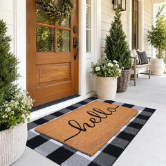Fallovea layered coir mat on top of plaid rug creating a dirt-trapping zone
