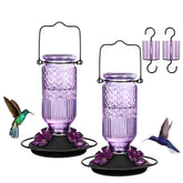 FEED GARDEN front view feeder showing glass bottle and purple base, highlights leak protection
