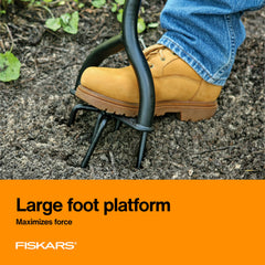 Close-up of Fiskars arrow-tipped tines penetrating soil, efficient clod breaking benefit