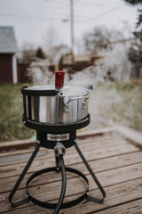 Gas One fryer in outdoor use frying chicken wings showing portability and party-ready benefit