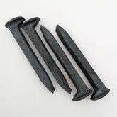 Generic brand front view of four new spikes showing heads and length, useful for crafting