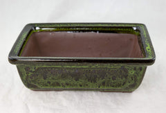 Generic planter seated on included rectangular tray showing fit and protection