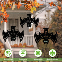 Hokfirm bats hanging from tree branch creating outdoor Halloween atmosphere