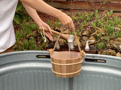 Home Sauna Experience cedar bucket hanging by rope handle for easy drying