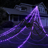 INST front view of lit purple spider web creating dramatic yard ambiance