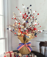 JEGERMIG front view of lighted red white blue tabletop tree showing festive shape and glow
