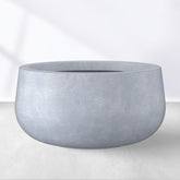 Kante planter front view showing modern round silhouette and charcoal finish
