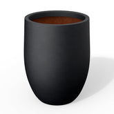Kante front view of black curved concrete planter showing silhouette and curb appeal