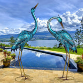 Kircust front view of paired heron sculptures showing lifelike garden presence