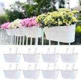 LáLáGreen front view of eight white rail planters, clean balcony styling benefit