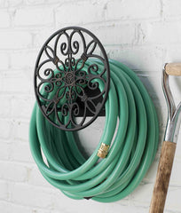 Liberty Garden 670 mounted near spigot with hose coiled demonstrates tidy garden organization