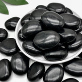 Mengdewei front of bag showing polished black river rocks and product weight