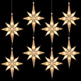 Mudder front view of eight window stars showing warm white glow and even coverage