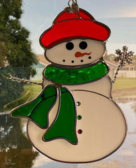 N2 snowman scale on table beside mug showing compact size and decorative impact