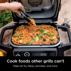 Ninja griddle clicked into OG700 grill demonstrating secure fit and even edge-to-edge heat