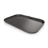 Ninja Woodfire griddle plate front view showing full black flat surface for even cooking