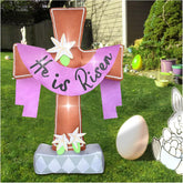 OILCUP front view of inflatable cross showing 'He is Risen' text and lilies, clear holiday focal point