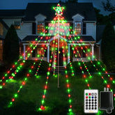 Ollny tree full front view in yard showing festive red and green lights and star topper, bright focal point
