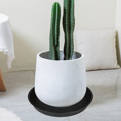 OVZILKI saucer under planter demonstrating stable fit and floor protection