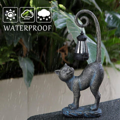 REYISO cat statue lit at night creating warm porch ambiance