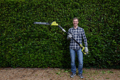 RYOBI full-length extended pole reaching high hedge for safe overhead trimming