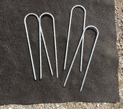 Sandbaggy staples driven into rocky soil demonstrating superior hold