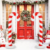 Simgoing front view of two candy cane inflatables showing festive curb appeal