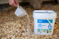 Strong Animals product scattered in coop to reduce odor and moisture