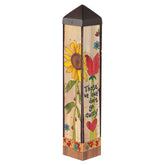 Studio M art pole front view showing full 20-inch decorative design and outdoor placement