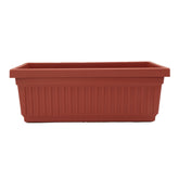 The HC Companies planter front view showing elegant fluted design and clay color