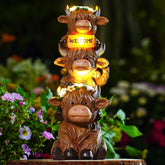 twinbling front view of stacked Highland cows showing welcome sign and floral accents for charm