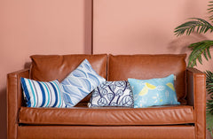 vmgreen pillow beside a ruler showing 11x16 size for travel and chair fit