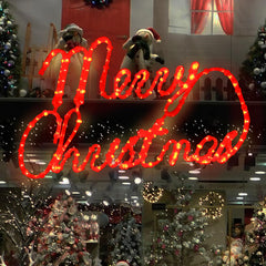 XMASLAND sign lit in a front yard at night delivering festive visibility and curb impact