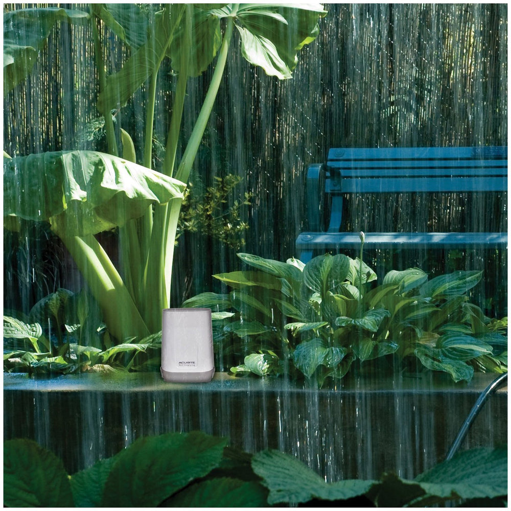 AcuRite rain gauge installed in garden demonstrating placement and yard protection
