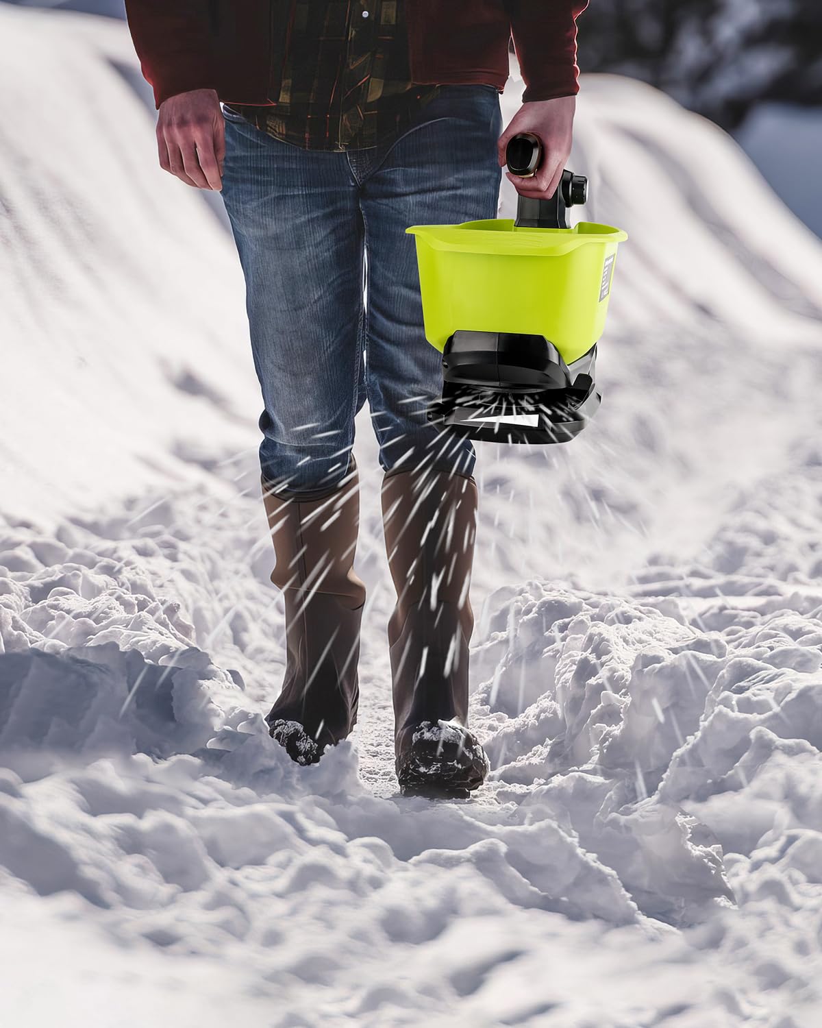 Adisipsoarin applying rock salt on sidewalk highlighting safe winter de-icing