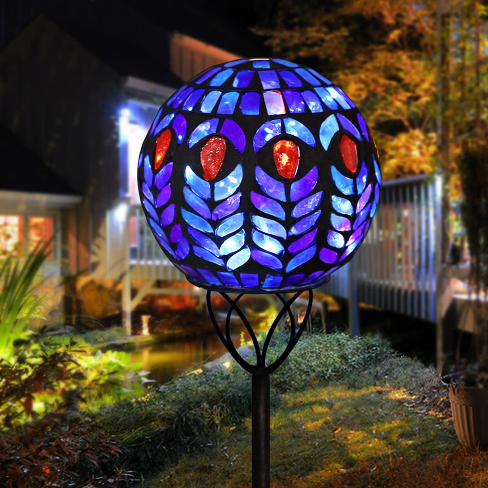 Afirst pathway scene with mosaic stakes adding color and soft lighting