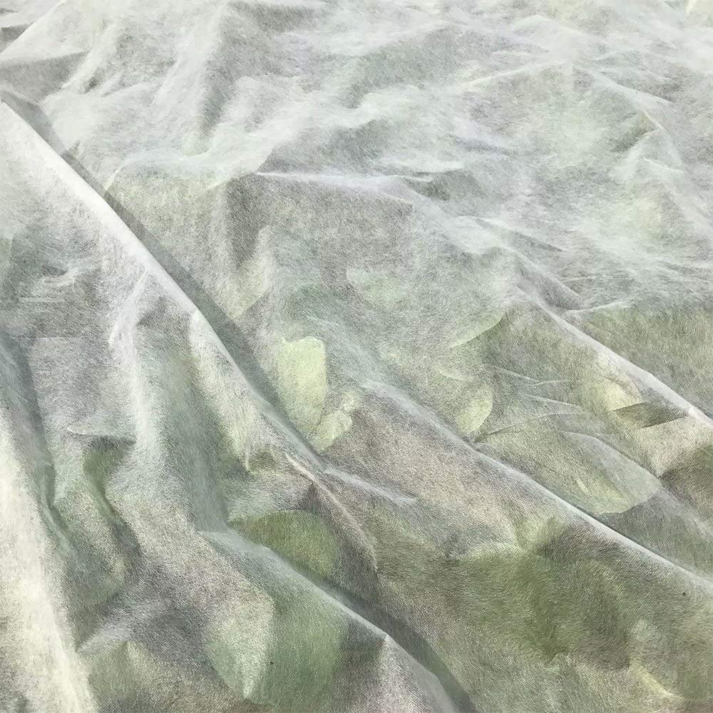 Agfabric lifestyle image gardener draping cover over raised beds for frost safety