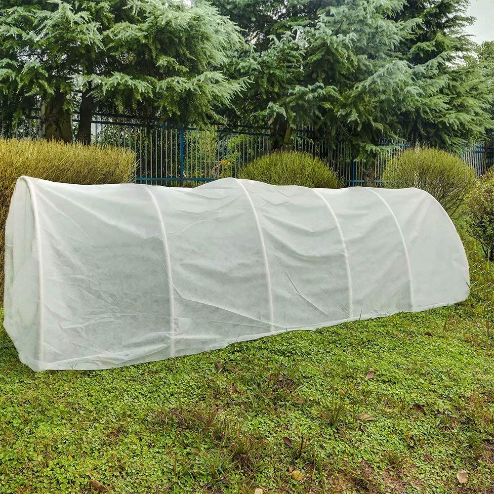 Agfabric roll beside gardening tools to show 6'x100' size scale