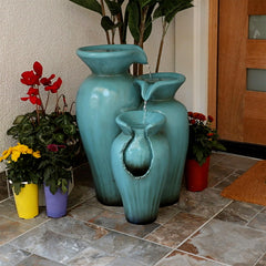 Alpine Corporation fountain front view showing turquoise finish and tiered pots for tranquil ambiance