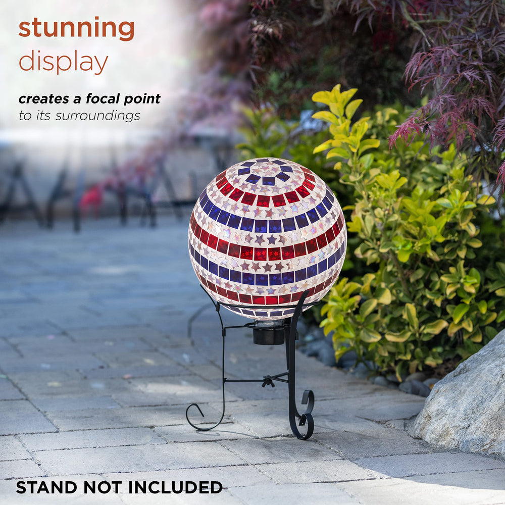 Alpine Corporation gazing globe in a garden bed adding patriotic color and light