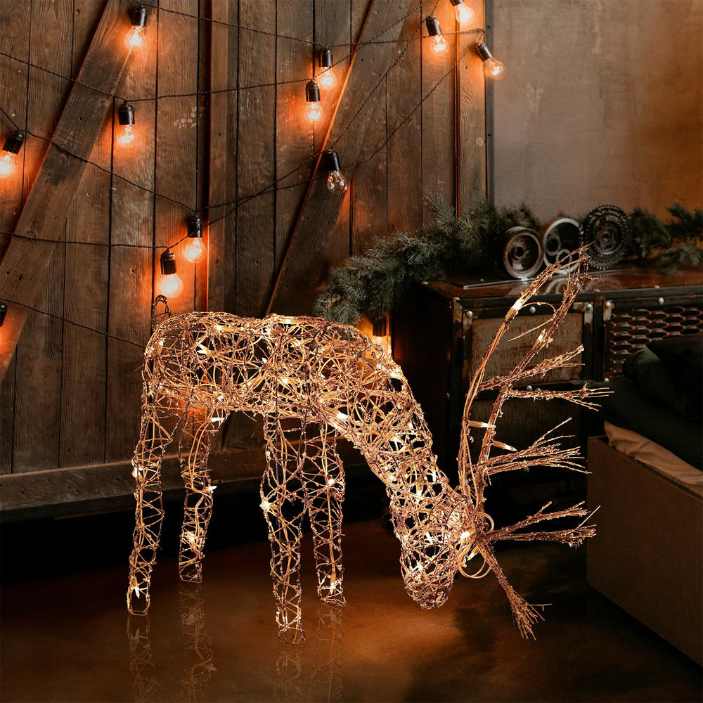 Alpine Corporation rattan reindeer front view showing warm white LEDs and festive curb appeal