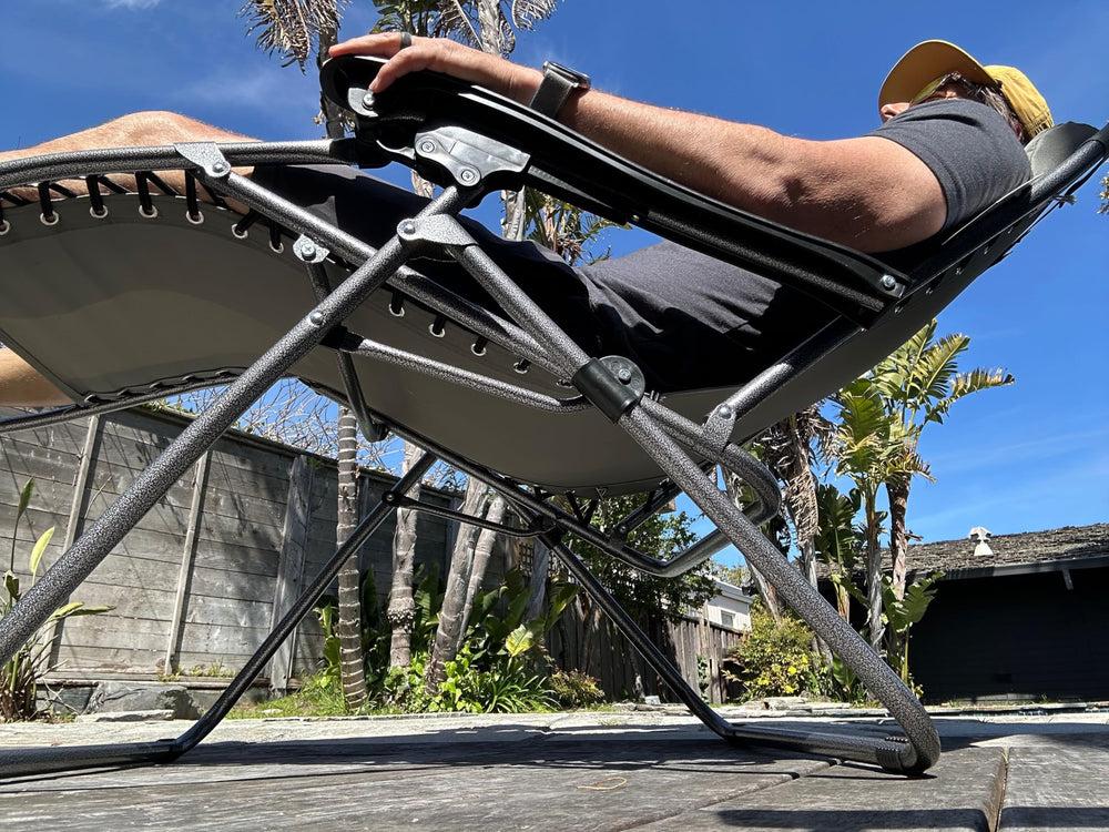 Alpine Mountain Gear chair at campsite showing comfort and convenient table access