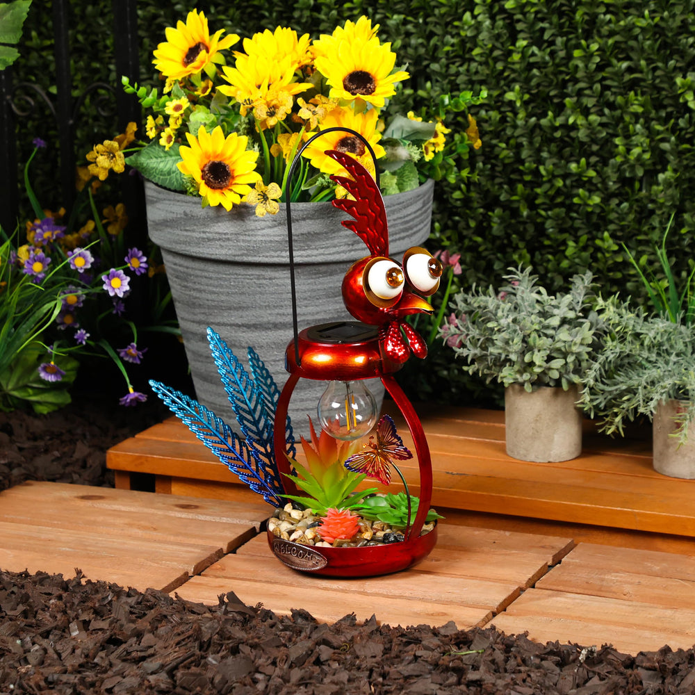 Alpine Corporation rooster placed in flower bed adding whimsical garden glow benefit