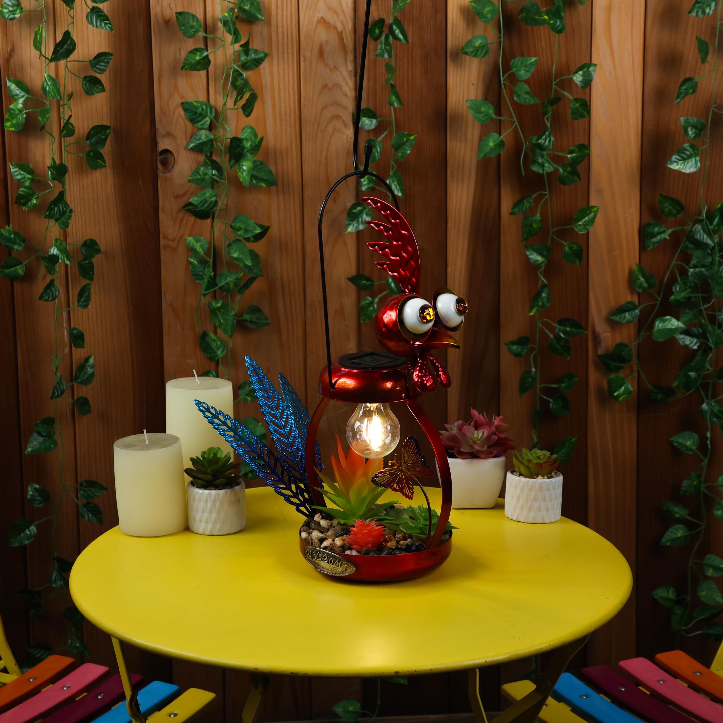 Alpine Corporation rooster on patio near planters providing soft evening ambiance benefit